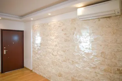 a room with a stone wall with a air conditioner at Luxury Villa with Pool in Athens Riviera in Lagonissi