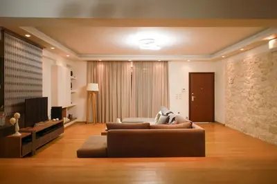 a living room with a couch and a television at Luxury Villa with Pool in Athens Riviera in Lagonissi