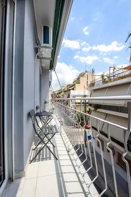 a balcony of a building with chairs on it at Spacious and modern one bedroom apartment in Athens