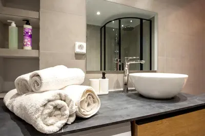 a bathroom with a sink and towels on a counter at Spacious and modern one bedroom apartment in Athens