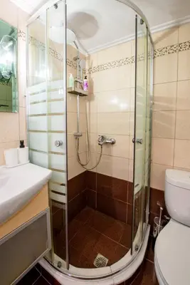 a bathroom with a shower with a toilet and a sink at Spacious and modern one bedroom apartment in Athens