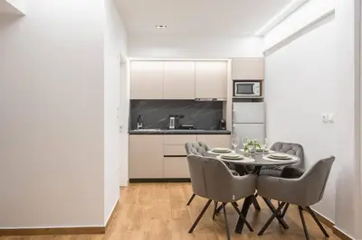 a kitchen and dining room with a table and chairs at Athens Loft in Athens