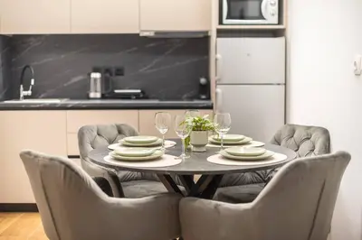 a table with chairs and plates and wine glasses at Athens Loft in Athens