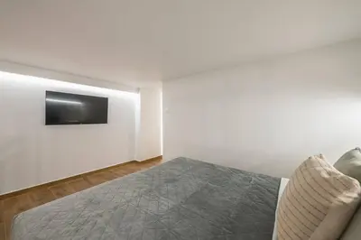 a bedroom with a bed and a tv on a wall at Athens Loft in Athens