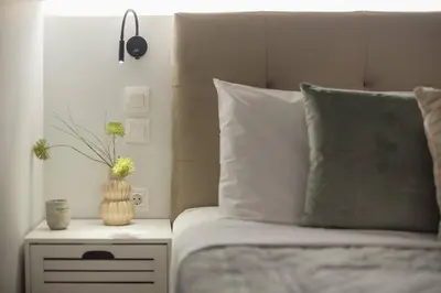 a bedroom with a bed with a vase on a night stand at Athens Loft in Athens