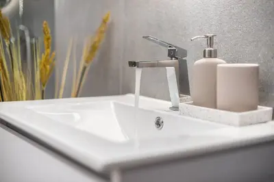 a white bathroom sink with a soap dispenser on it at Athens Loft in Athens
