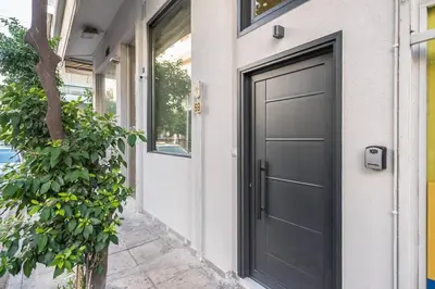 a black garage door on a house at Athens Loft in Athens