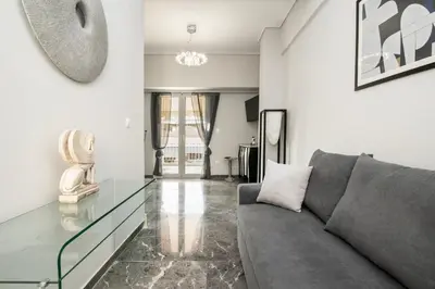 a living room with a couch and a glass table at Tsil House in Athens