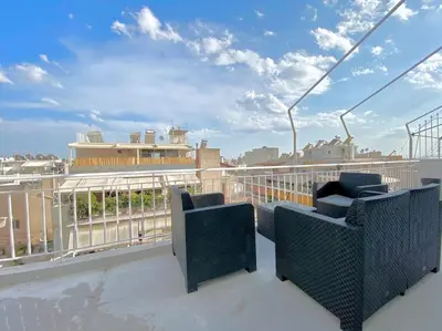 a balcony with chairs and a view of a city at Tsil House in Athens