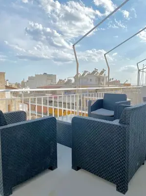 a balcony with chairs and a table on a ship at Tsil House in Athens