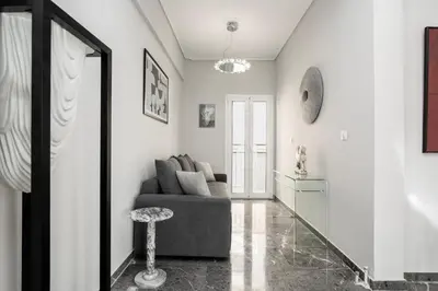 a living room with a couch and a table at Tsil House in Athens