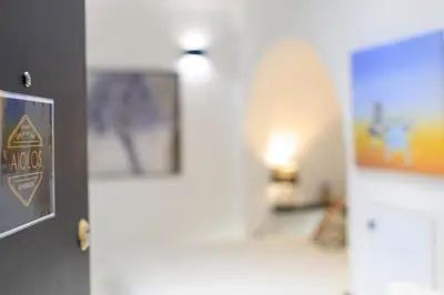 a hallway with a door and a picture on the wall at Aiolos luxury apartment under acropolis in plaka in Athens