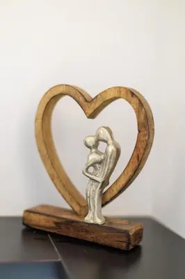 a small metal statue of a person forming a heart at Aiolos luxury apartment under acropolis in plaka in Athens