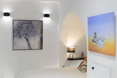 a white room with a picture on the wall at Aiolos luxury apartment under acropolis in plaka in Athens