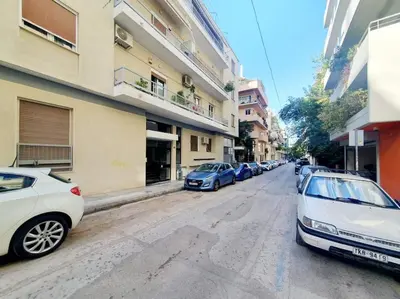 a row of parked cars parked on a city street at George's Cozy 60m2 Apartment 7' Metro in Athens