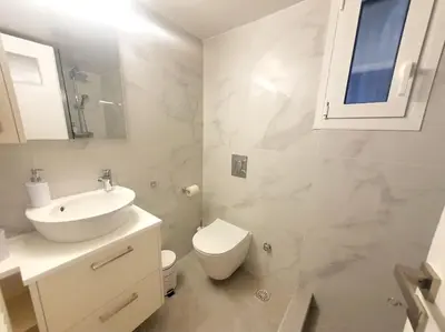 a white bathroom with a sink and a toilet at George's Cozy 60m2 Apartment 7' Metro in Athens