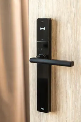 a black door handle on a wooden door at The Meta Stay - Rooftop Access Central Studio in Athens