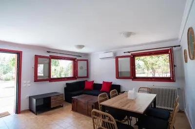 a living room with a couch and a table at Oregano peaceful complex in Porto Rafti