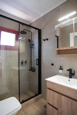 a bathroom with a shower and a sink at Oregano peaceful complex in Porto Rafti
