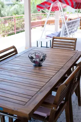 a wooden table with a bowl on top of it at Oregano peaceful complex in Porto Rafti