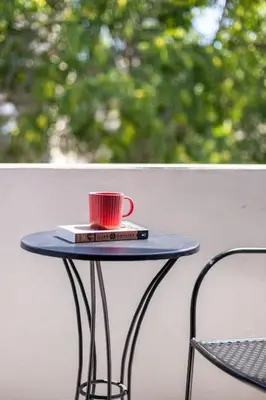 a table with a red cup on top of it at The Meta Stay - Rooftop Access Downtown Suite in Athens