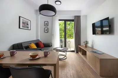 a living room with a couch and a table at The Meta Stay - Rooftop Access Downtown Suite in Athens