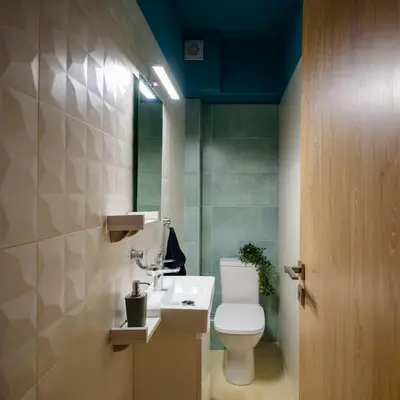 a bathroom with a toilet and a sink and a mirror at Charming apartment Galatsi for 5 by MPS in Athens