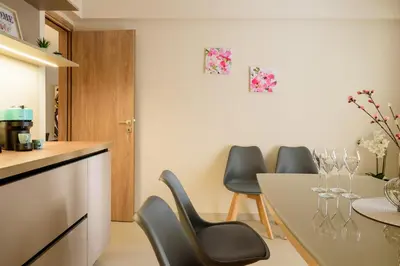 a kitchen with chairs and a table with wine glasses at Charming apartment Galatsi for 5 by MPS in Athens