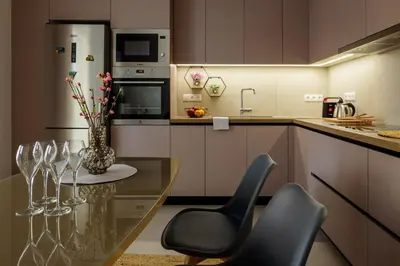 a kitchen with a glass table and chairs with wine glasses at Charming apartment Galatsi for 5 by MPS in Athens