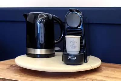 a coffee maker and a cup sitting on a counter at The Captain Suite in Athens