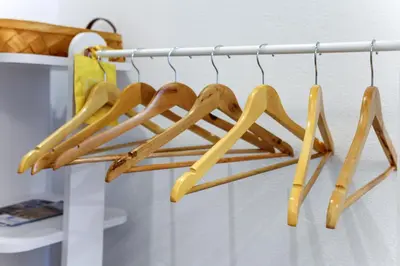 a group of wooden hangers hanging on a rack at The Captain Suite in Athens