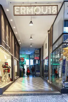 an empty shopping mall with a sign that reads emporium at The Captain Suite in Athens