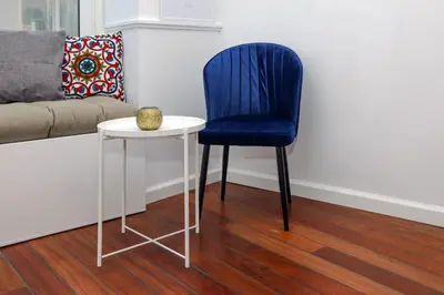 a blue chair next to a table and a couch at The Captain Suite in Athens