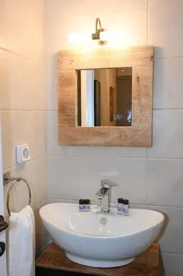 a bathroom with a white sink and a mirror at Elida Inn Near ATH Airport in Markopoulo