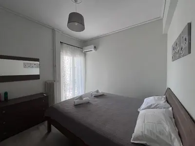 a bedroom with a bed with two towels on it at Miranda's Apartment Koukaki in Athens