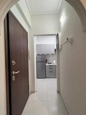 a hallway with a door leading to a kitchen at Miranda's Apartment Koukaki in Athens