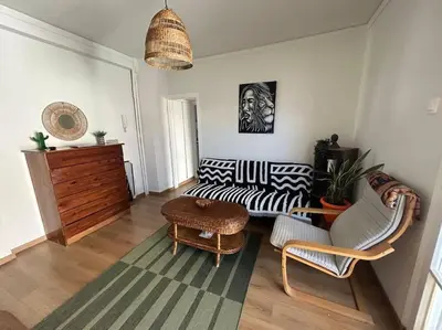 a living room with a couch and a table at Bohemian Cozy Flat, with terrace 24h available, self- check in in Athens
