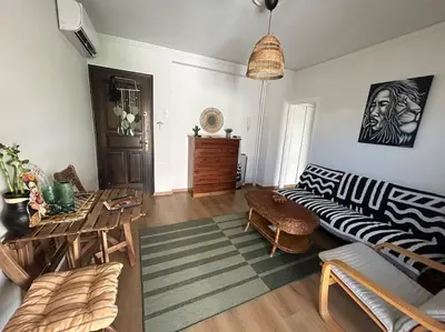 a living room with a couch and a table at Bohemian Cozy Flat, with terrace 24h available, self- check in in Athens