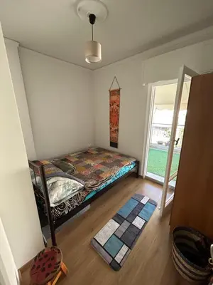 a small bedroom with a bed and a window at Bohemian Cozy Flat, with terrace 24h available, self- check in in Athens