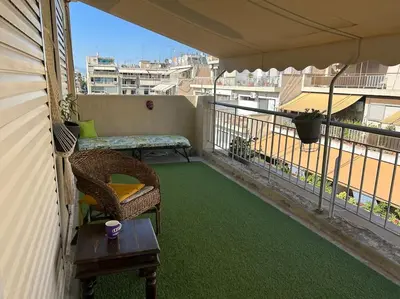 a balcony with a table and a chair on a balcony at Bohemian Cozy Flat, with terrace 24h available, self- check in in Athens