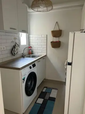 a kitchen with a washing machine and a sink at Bohemian Cozy Flat, with terrace 24h available, self- check in in Athens