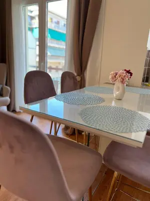 a table with chairs and a vase of flowers on it at Acropolis Sidewalk view in Athens