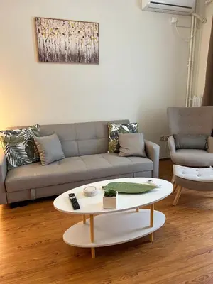a living room with a couch and a coffee table at Acropolis Sidewalk view in Athens