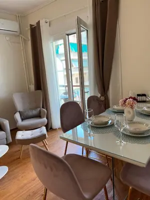 a dining room with a table and chairs at Acropolis Sidewalk view in Athens