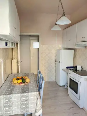 a kitchen with a table with a plate of fruit on it at Φωτεινό δίκλινο δωμάτιο με θέα! in Athens