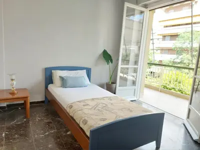a bedroom with a bed and a large window at Δωμάτιο για χαλάρωση με θέα in Athens