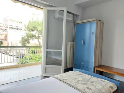 a bedroom with a blue cabinet and a window at Δωμάτιο για χαλάρωση με θέα in Athens