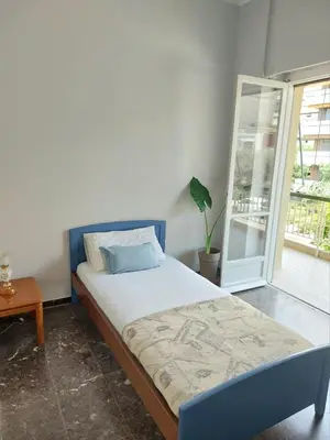 a bedroom with a bed and a potted plant at Δωμάτιο για χαλάρωση με θέα in Athens