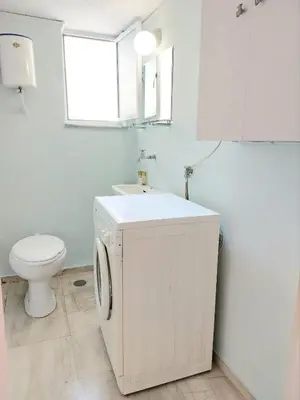 a white bathroom with a sink and a toilet at Ήσυχο φωτεινό δωμάτιο με βεράντα in Athens