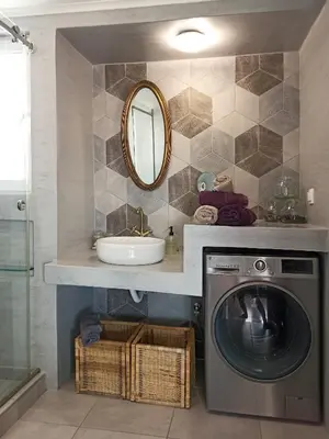 a bathroom with a washing machine and a sink at Terrace holiday studio apartment in Athens